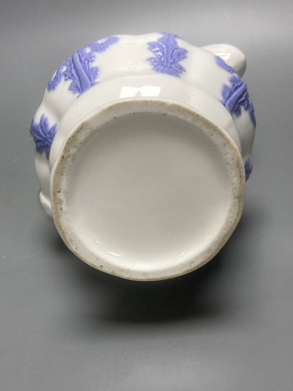 Four early 19th century Staffordshire jugs, each with lilac coloured floral applied panels, one dated 1826, tallest 22cm
